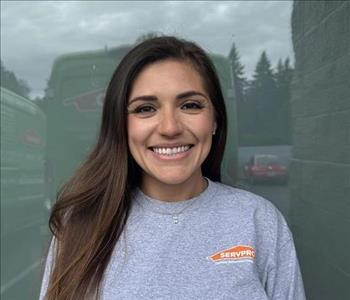 SERVPRO employee in front of beige background. 