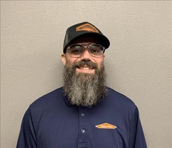 SERVPRO employee in front of beige background. 